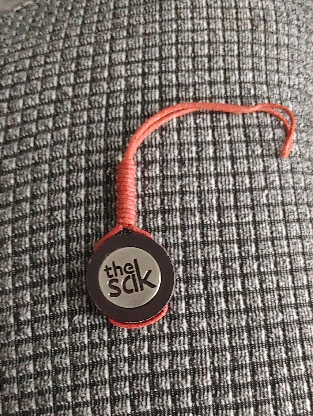 The Sak Rust Red Leather Logo Charm with Woven Loop-Replacement Tag